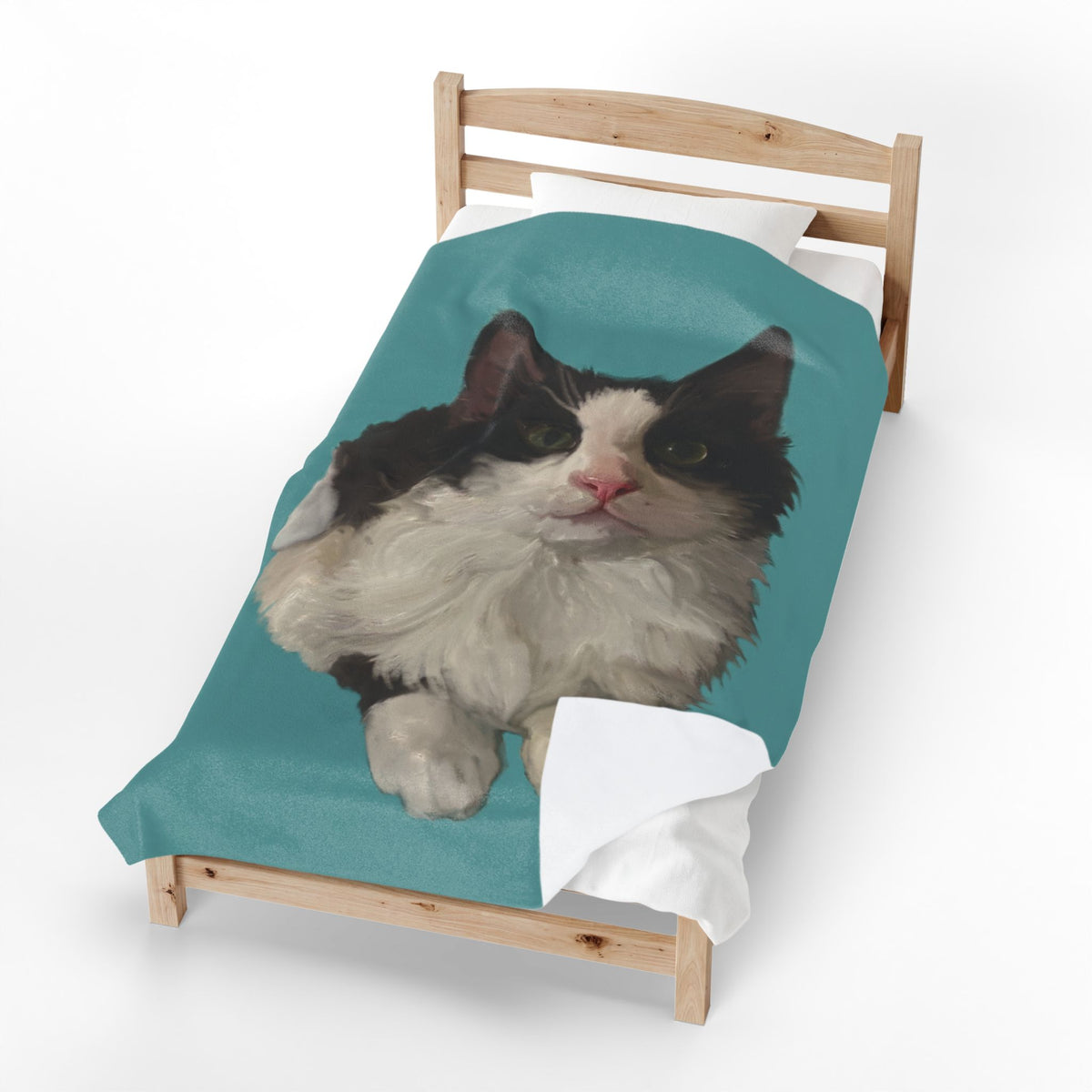 Personalized pet photo blanket on a wooden chair, teal plush with black-and-white cat portrait