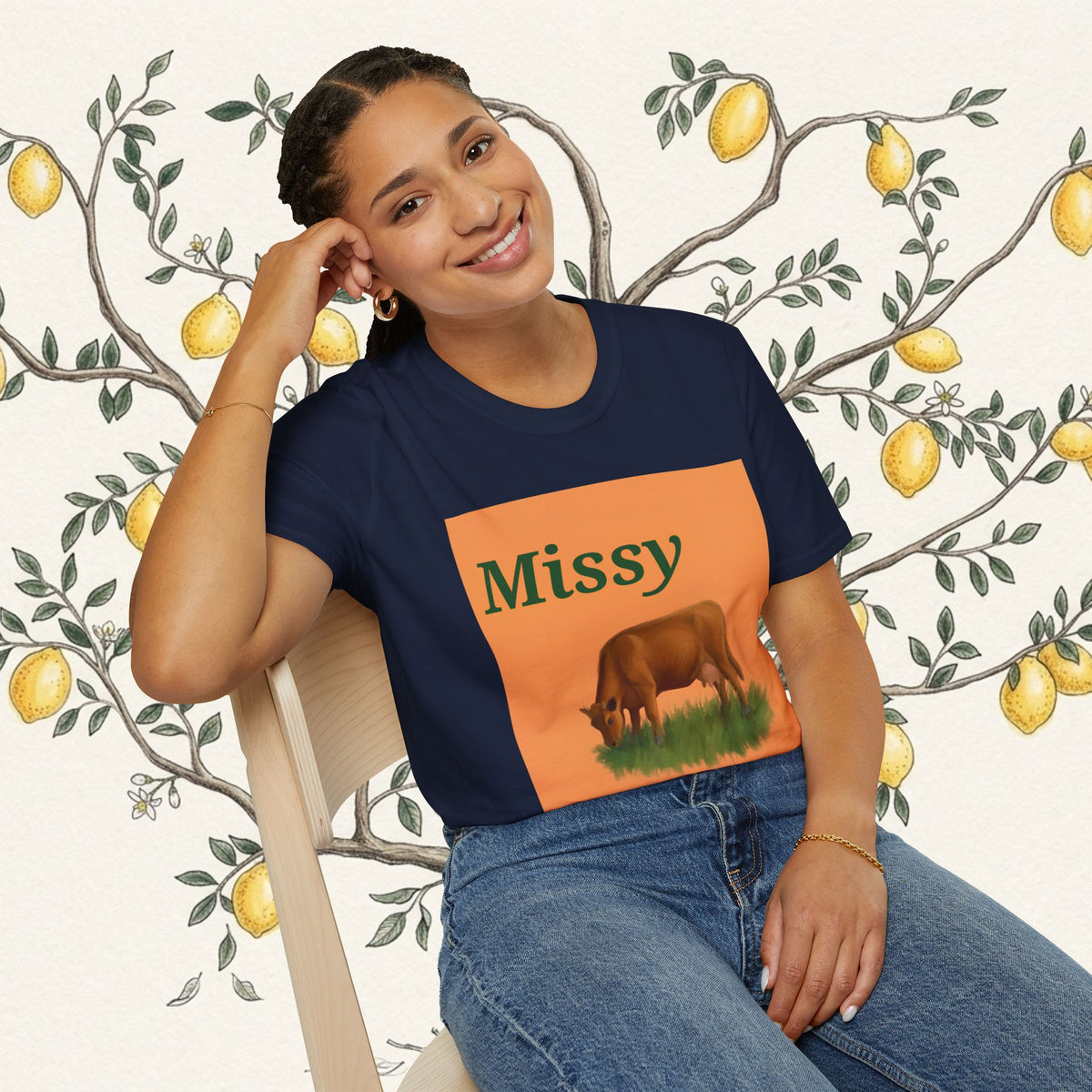Navy t-shirt with orange 'Missy' square graphic featuring a grazing cow