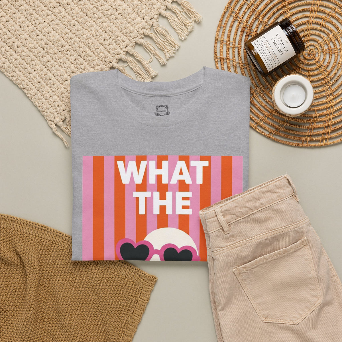 Light gray crewneck T-shirt with “WHAT THE” duck graphic and heart sunglasses