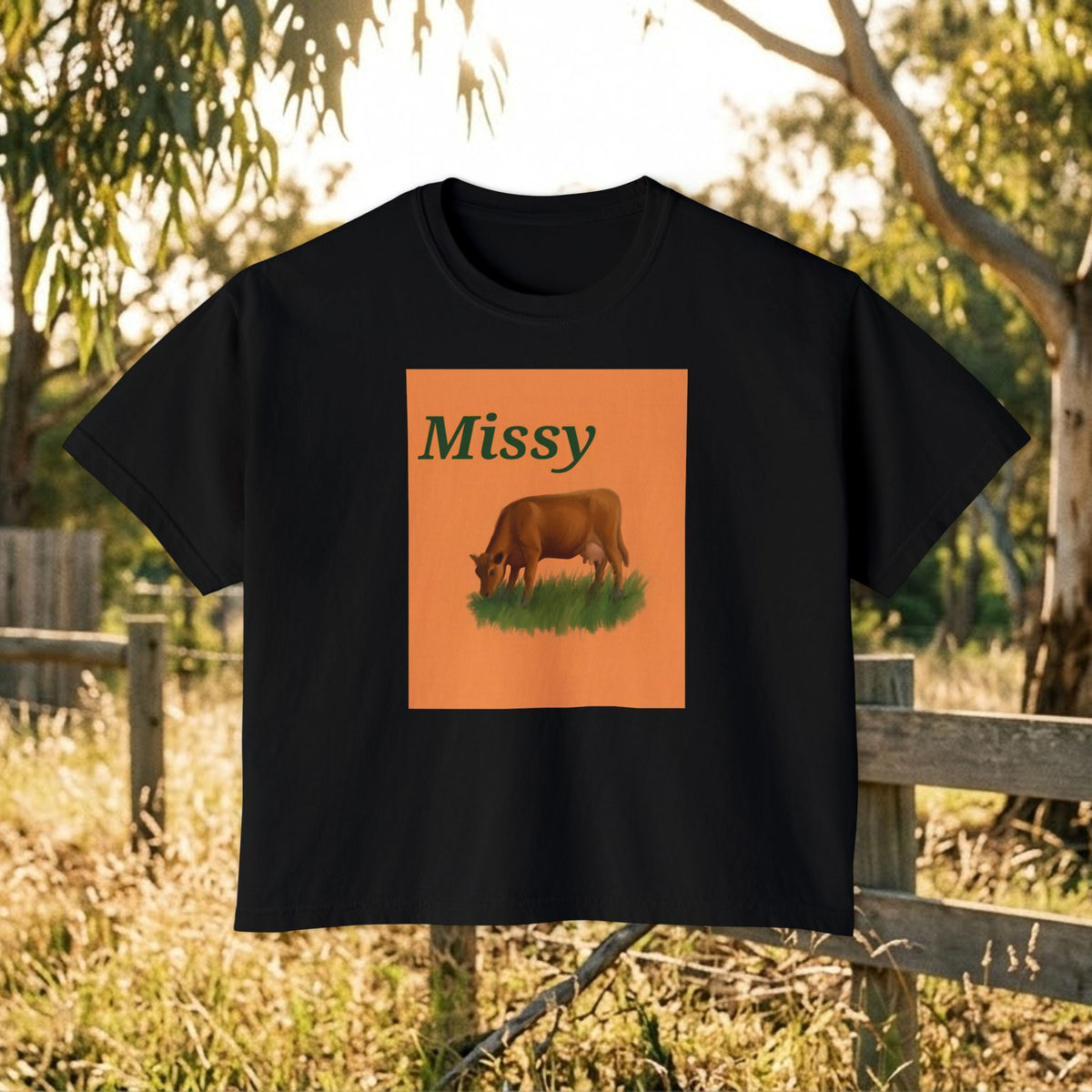 Women’s boxy graphic tee in black with 'Missy' cow illustration on front