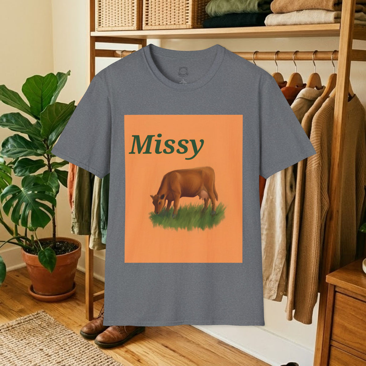 Slate blue crew-neck t-shirt with orange square “Missy” grazing cow graphic
