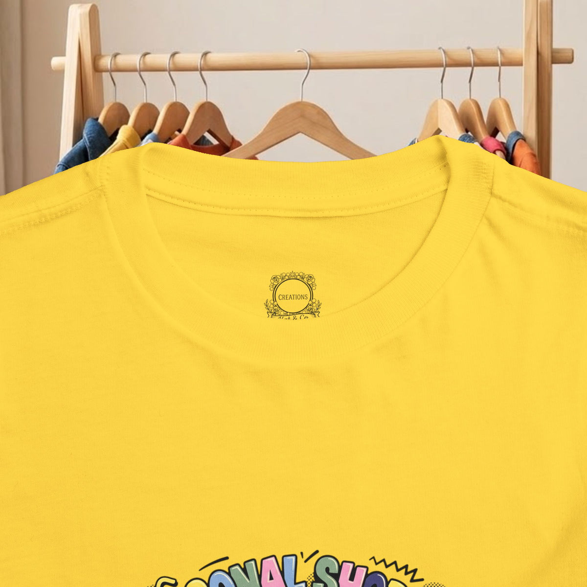 Yellow toddler t-shirt with small chest logo and partial front graphic