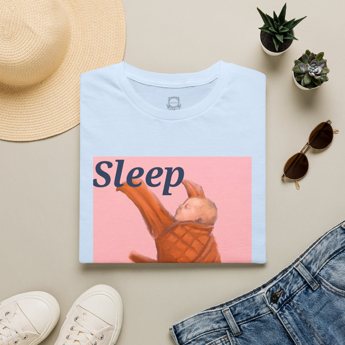 Light blue t-shirt with “Sleep” sleeping baby graphic