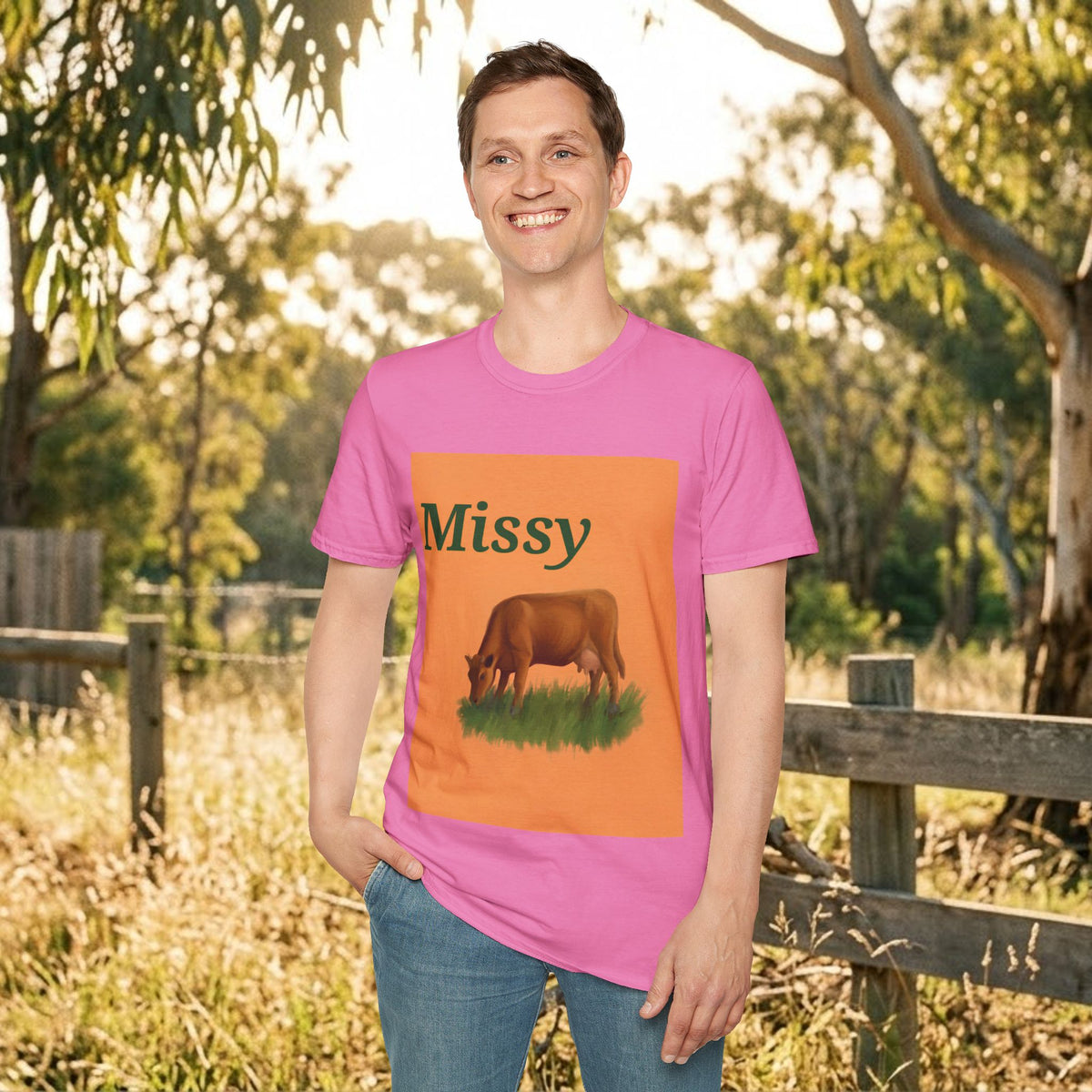 Pink cow graphic t-shirt with orange square graphic and grazing cow artwork
