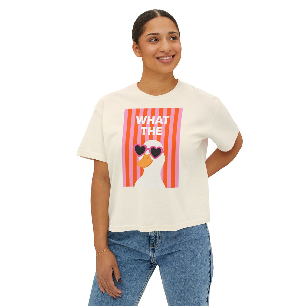 Ivory boxy crop graphic tee with “WHAT THE” text and duck with heart glasses
