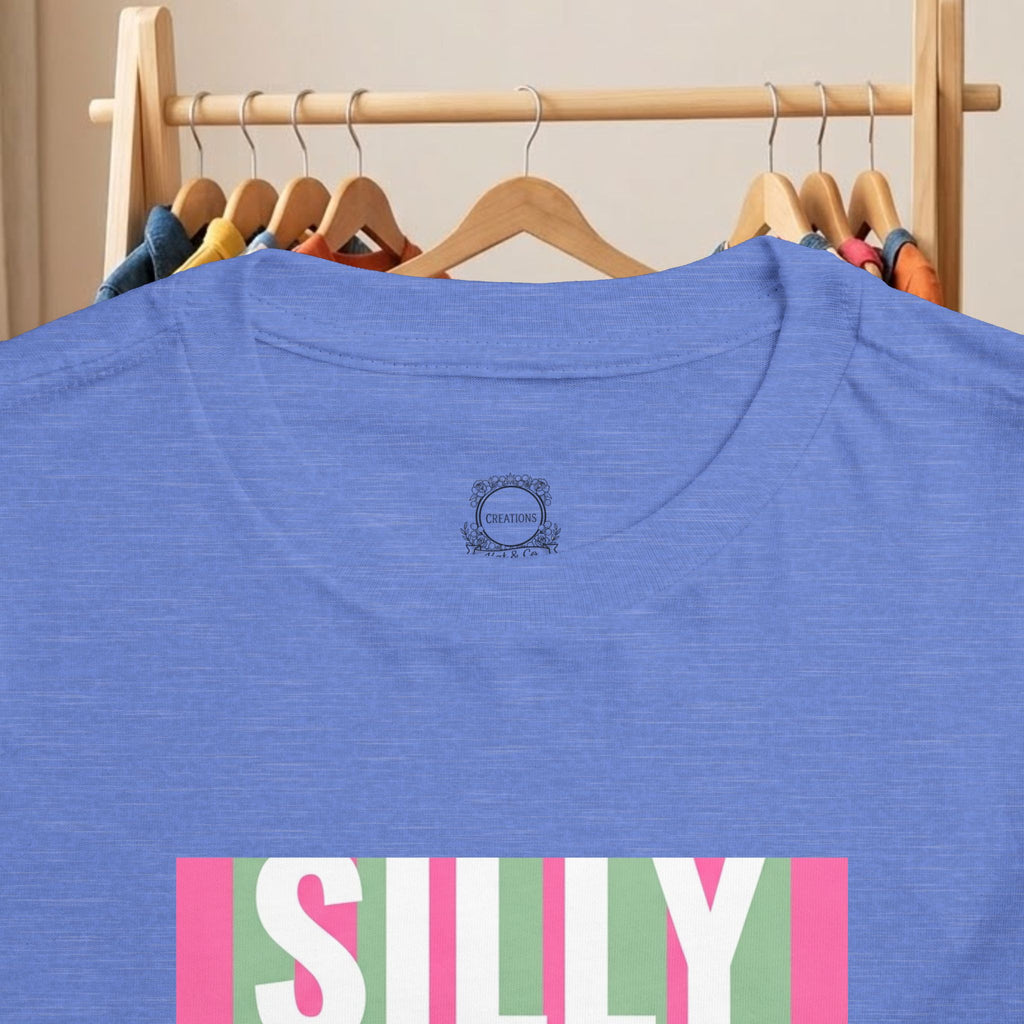 Toddler blue tee back view with small logo patch and partial “SILLY” graphic