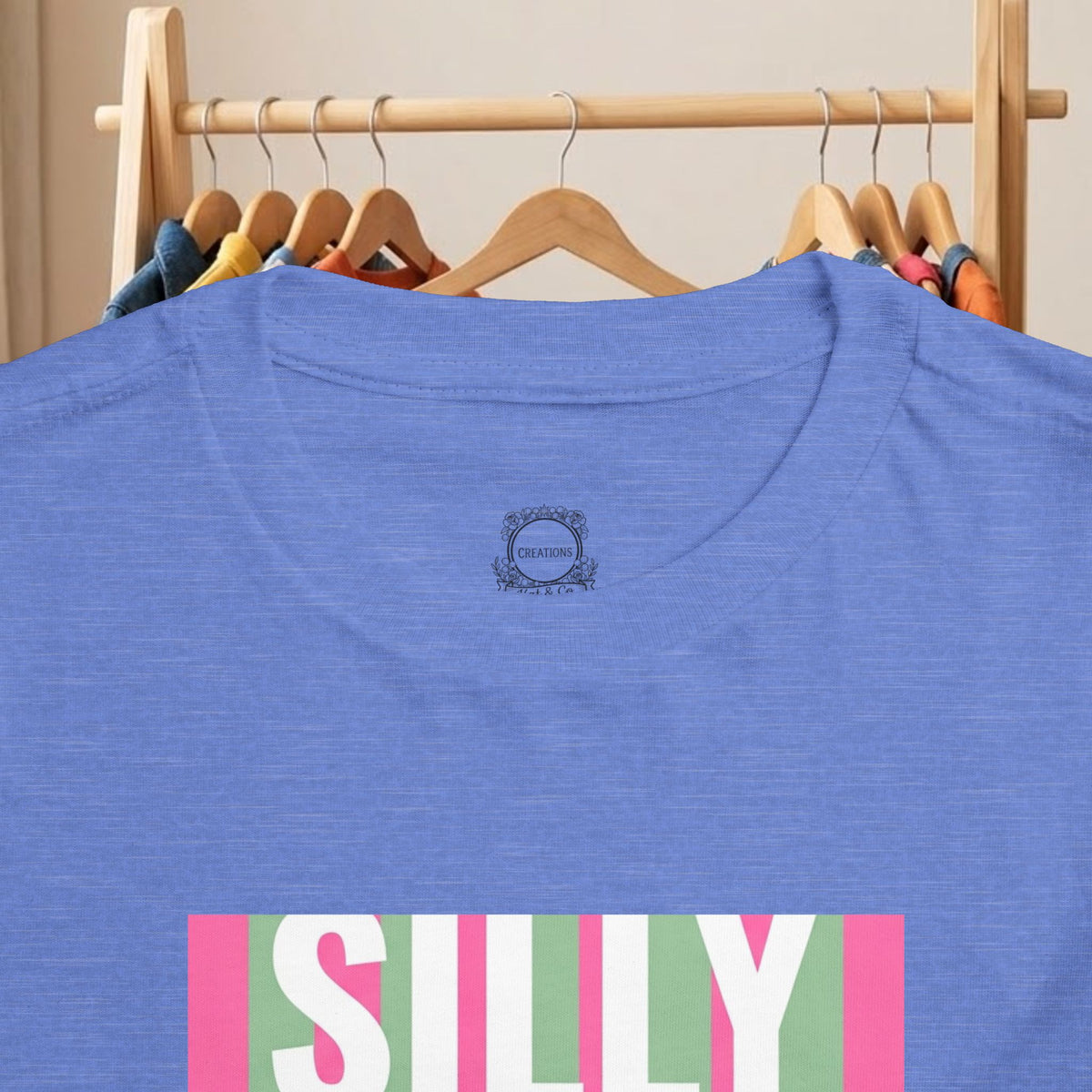 Toddler blue tee back view with small logo patch and partial “SILLY” graphic