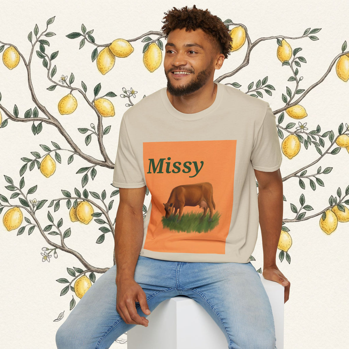 Cream short-sleeve T-shirt with orange square cow graphic and “Missy” text