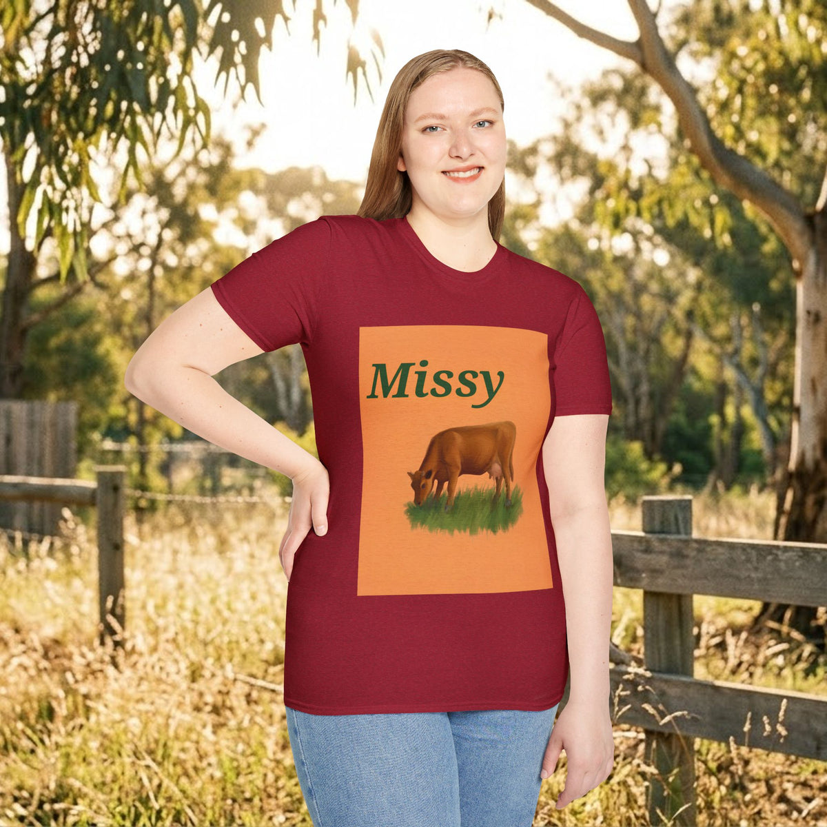 Maroon T-shirt with Missy and grazing cow illustration, worn outdoors