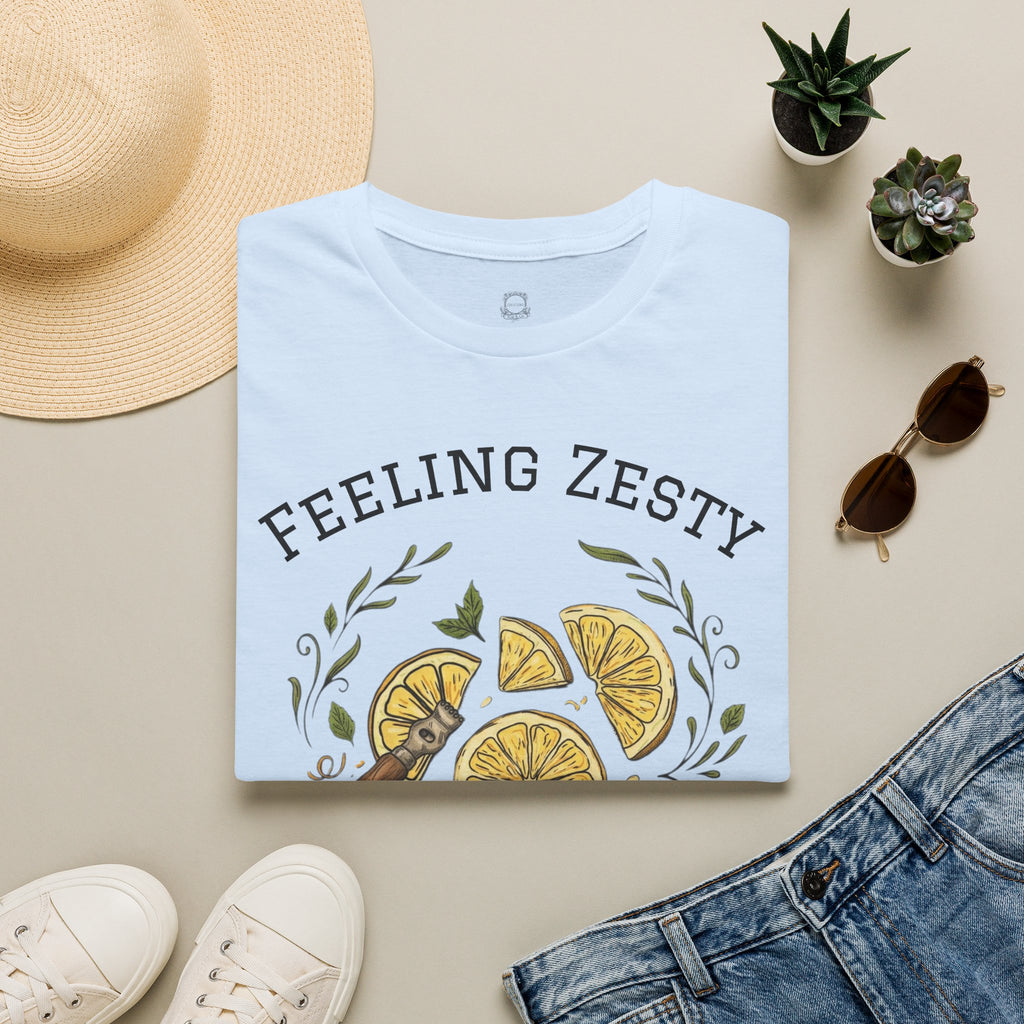 Light blue crewneck graphic tee, front shows "FEELING ZESTY" and citrus slice artwork
