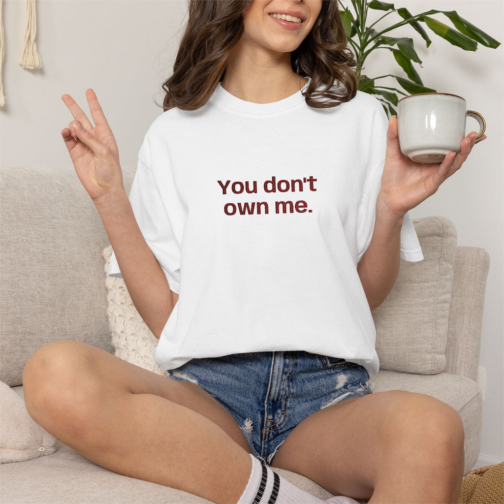 White T-shirt worn by a woman; "You don't own me." slogan printed on the chest.