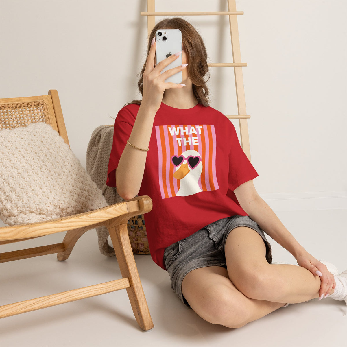 Red unisex crewneck T-shirt with “WHAT THE” heart sunglasses graphic on chest
