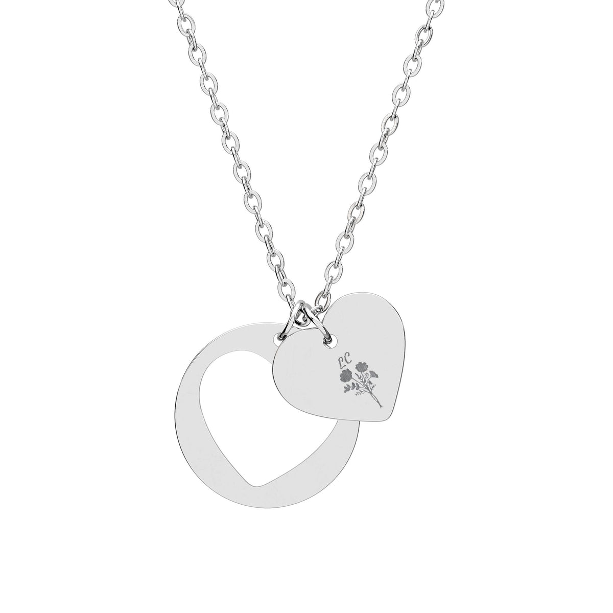 Silver heart cutout pendant necklace with engraved emblem, linked chain