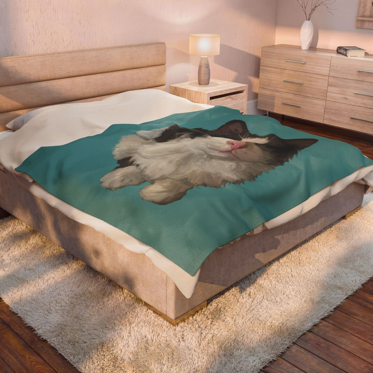 Personalized pet photo blanket draped on bed, teal plush with black-and-white cat portrait