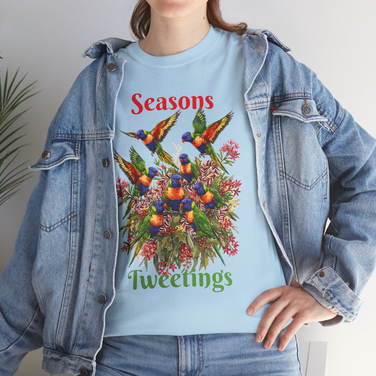 Light blue T-shirt with colorful bird floral holiday graphic and 'Seasons Tweetings' text