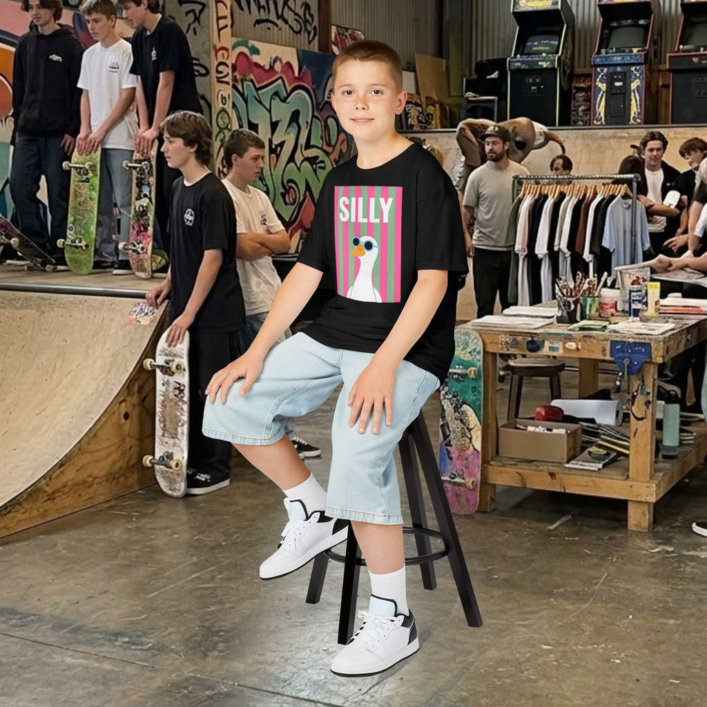 Black kids T-shirt with SILLY duck graphic, wearing on stool