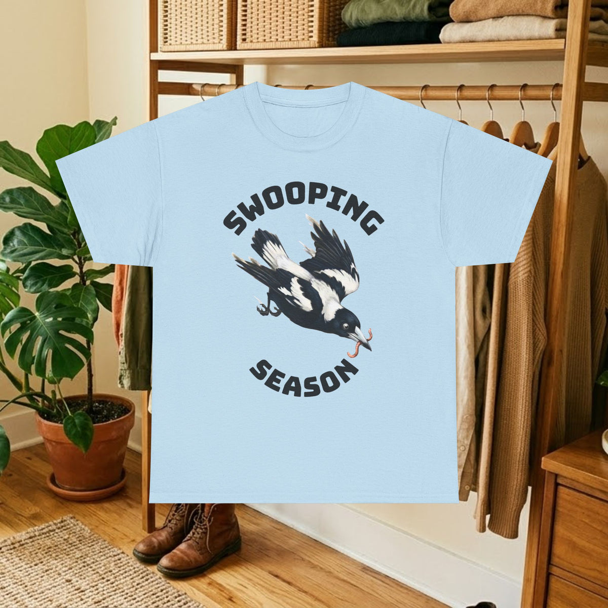 Light blue t-shirt with black bird graphic and "SWOOPING SEASON" text