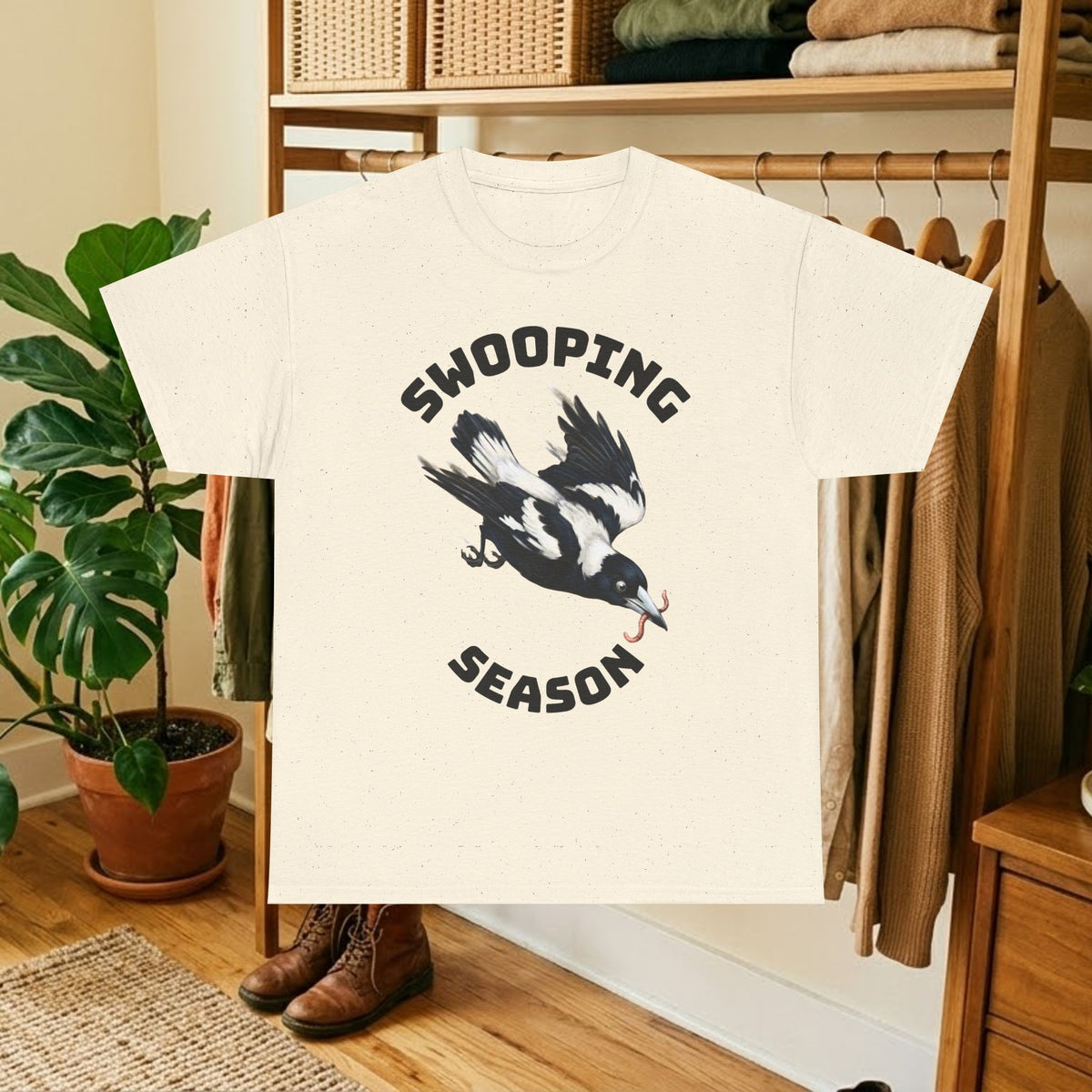 Natural/off-white t-shirt with black bird graphic and "SWOOPING SEASON" text