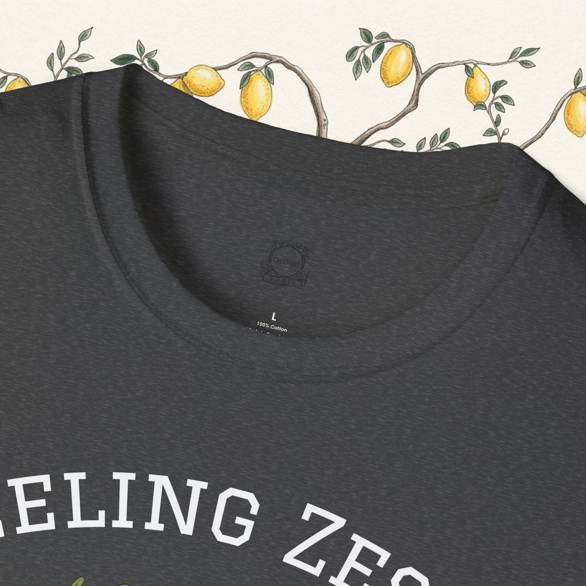 Dark heather crewneck t-shirt close-up showing neckline and “FEELING ZESTY” print