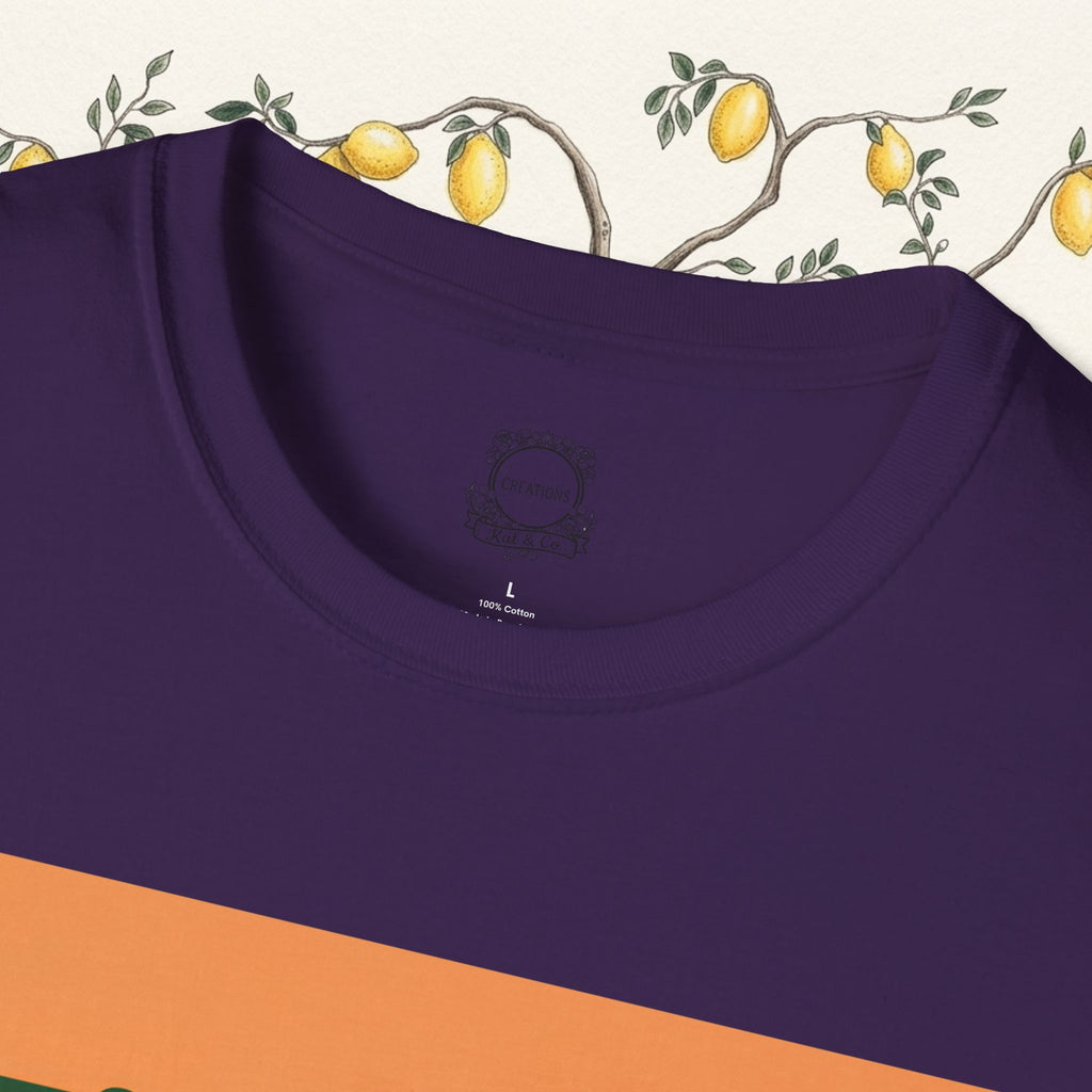 Purple crew-neck T-shirt with orange Missy graphic and grazing cow partial