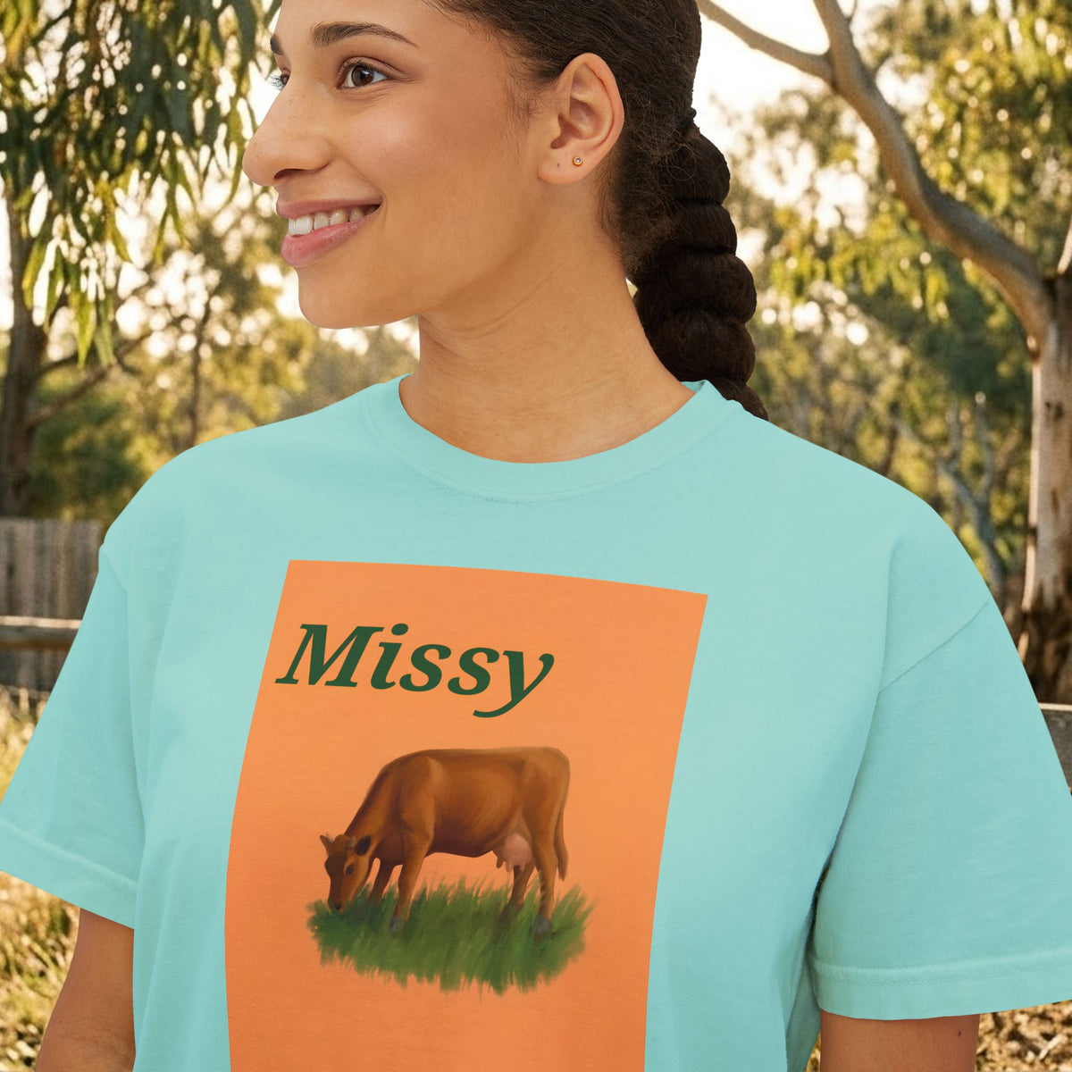 Women’s boxy graphic tee in light blue with 'Missy' cow illustration on front