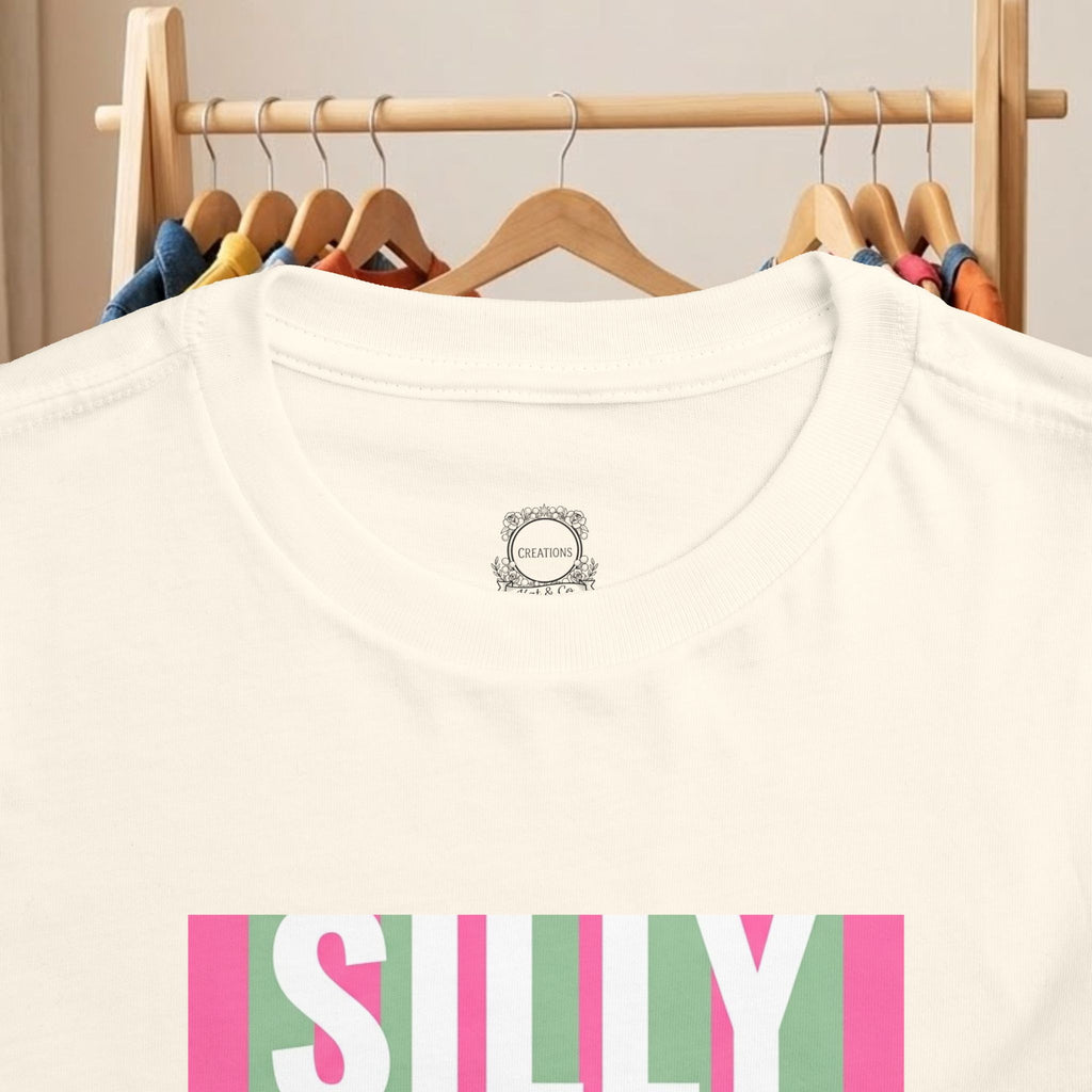 Toddler cream T-shirt with small backneck logo and “SILLY” duck graphic detail