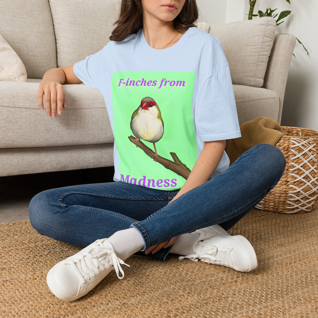 Light blue t-shirt with green panel bird illustration and purple text graphic