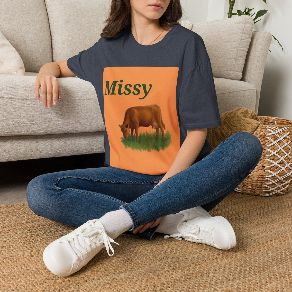 Navy t-shirt worn with orange 'Missy' cow graphic and blue jeans
