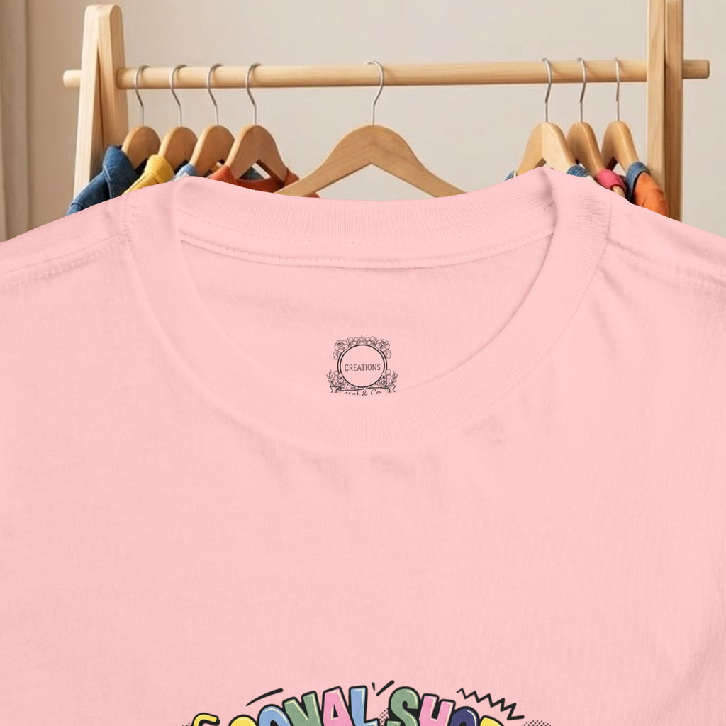 Pink toddler T-shirt close-up of crew neck logo and top of graphic