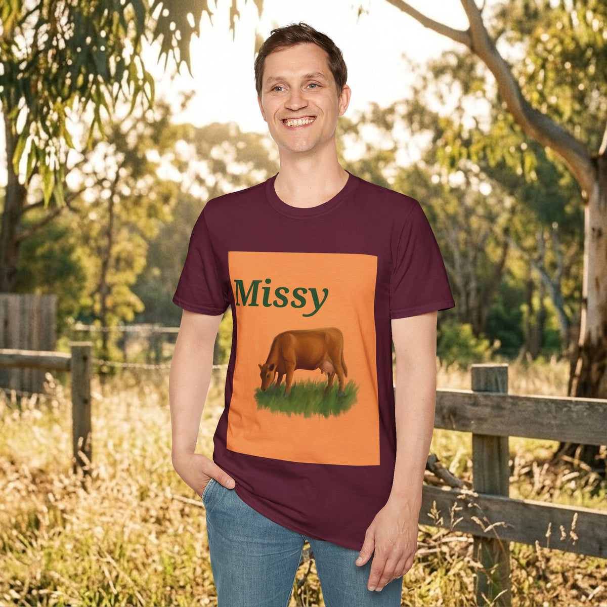 Maroon crewneck T-shirt on model with orange “Missy” cow graphic centered on chest