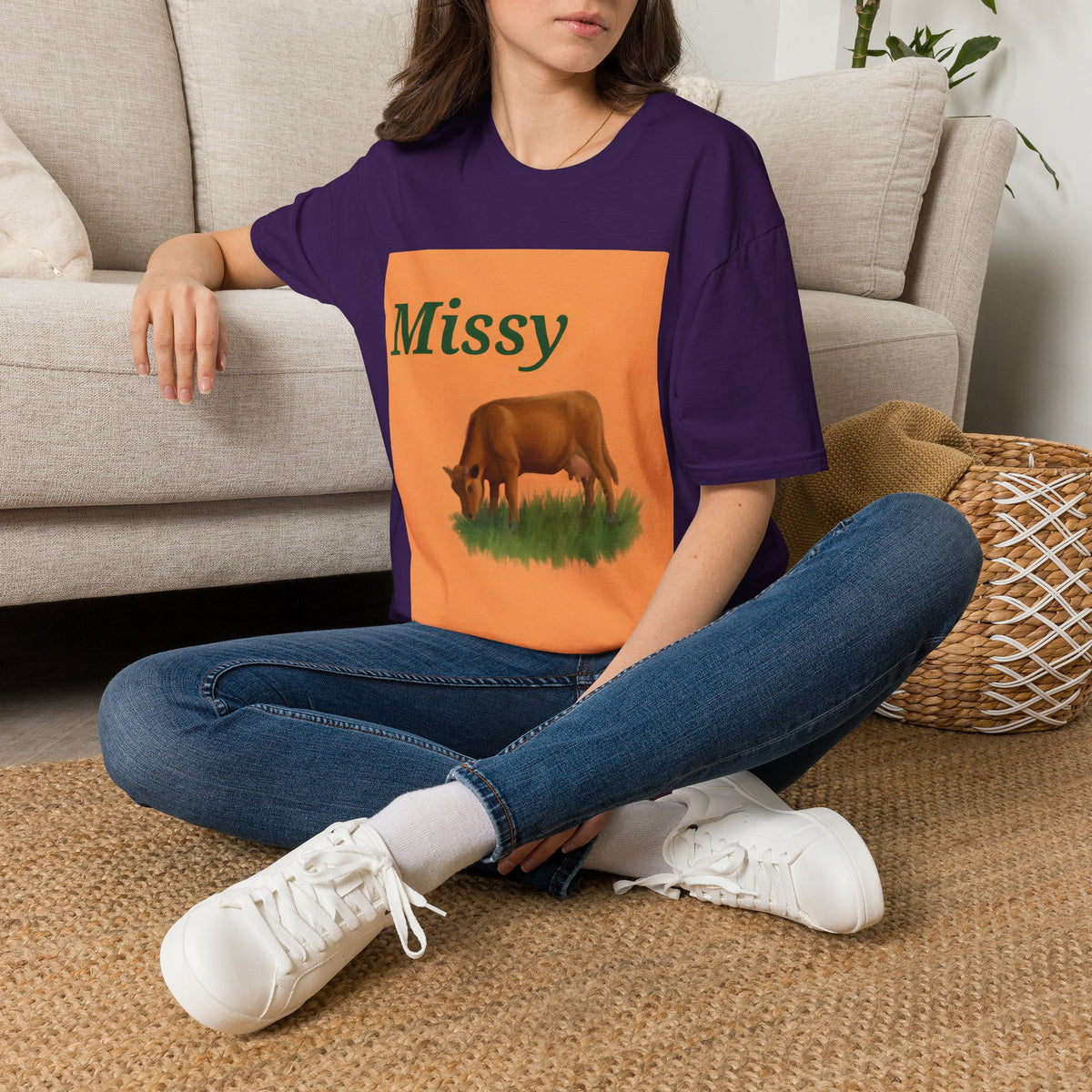 Purple crew-neck T-shirt with orange Missy panel and grazing cow graphic