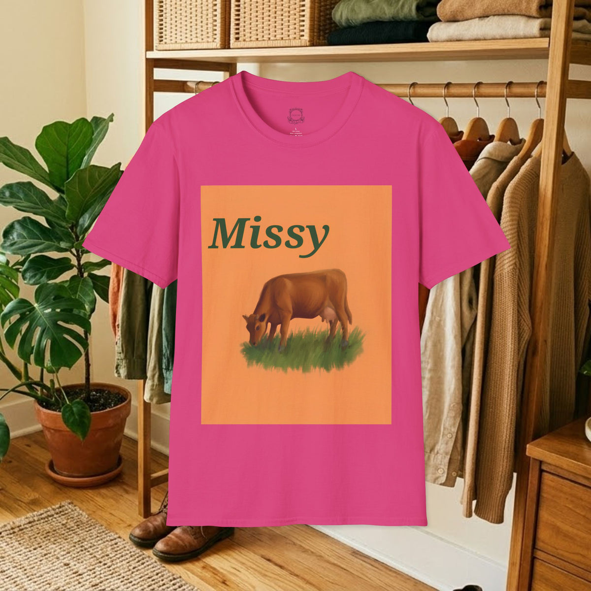 Hot pink short-sleeve T-shirt with orange “Missy” cow graphic on front