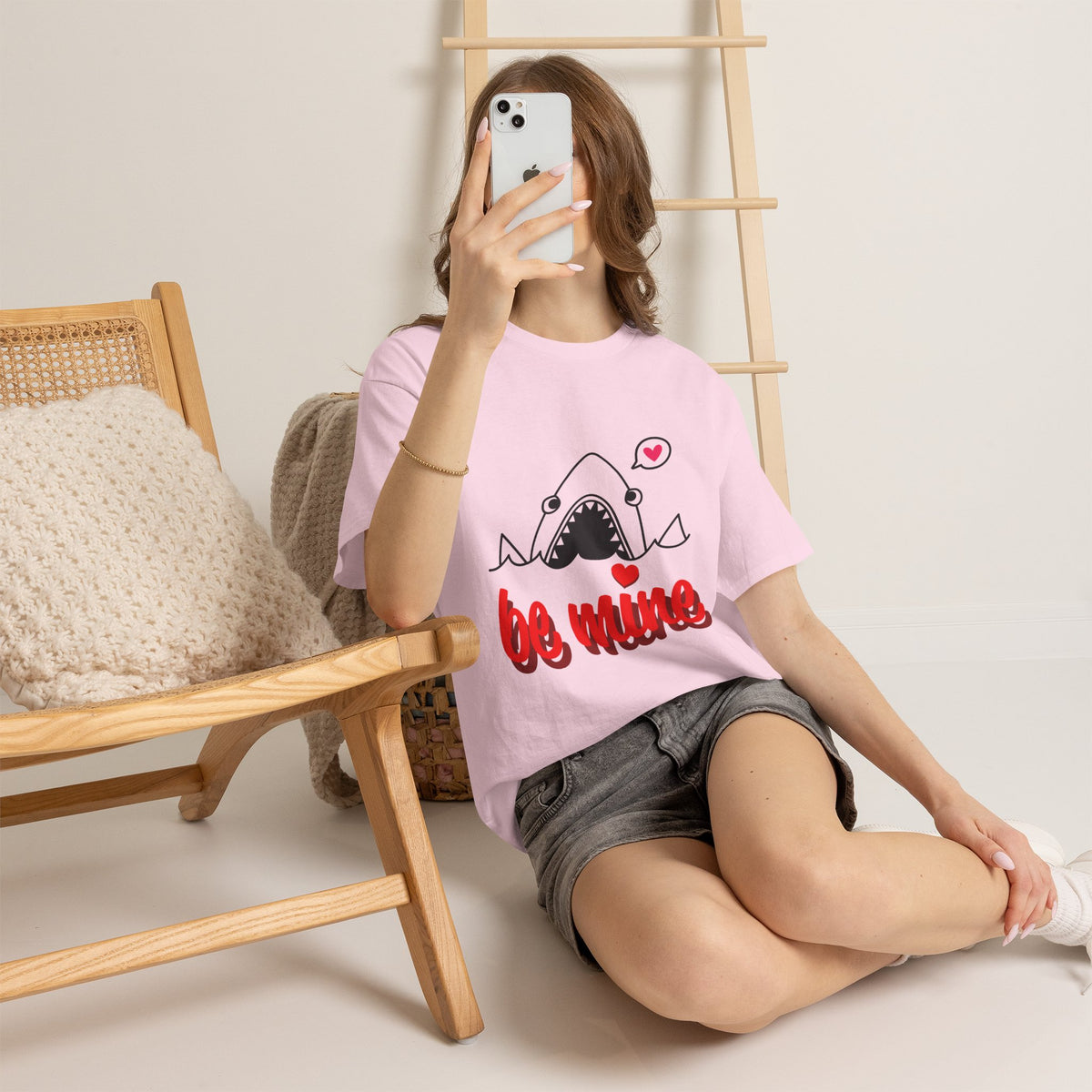 Light pink T-shirt with cartoon shark and red “be mine” graphic, worn by model