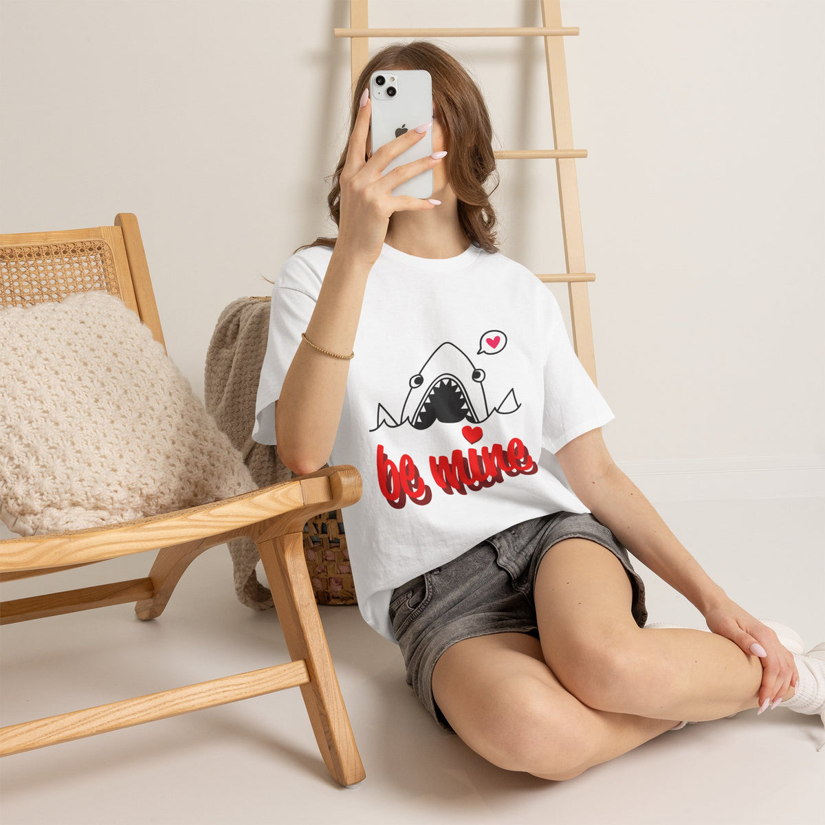White T-shirt on model with shark graphic and red "be mine" heart design