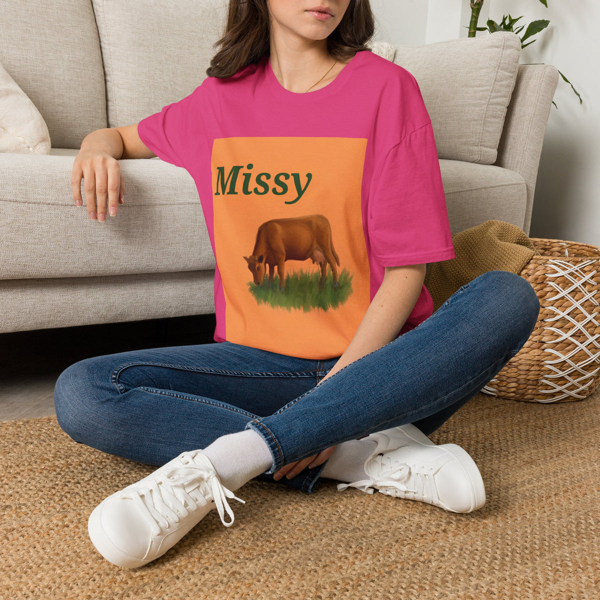 Pink crewneck t-shirt with orange cow illustration panel and “Missy” text, worn