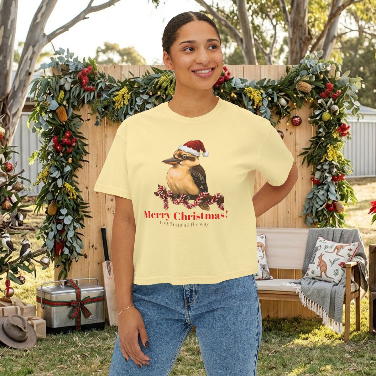 Light yellow crewneck t-shirt with printed Santa-hat bird and “Merry Christmas” text