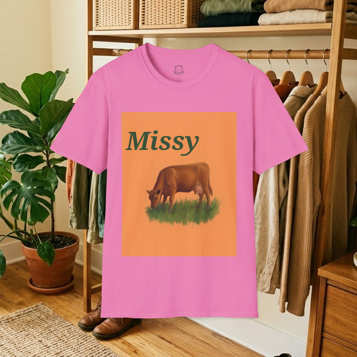 Pink short-sleeve T-shirt with orange “Missy” cow graphic on front