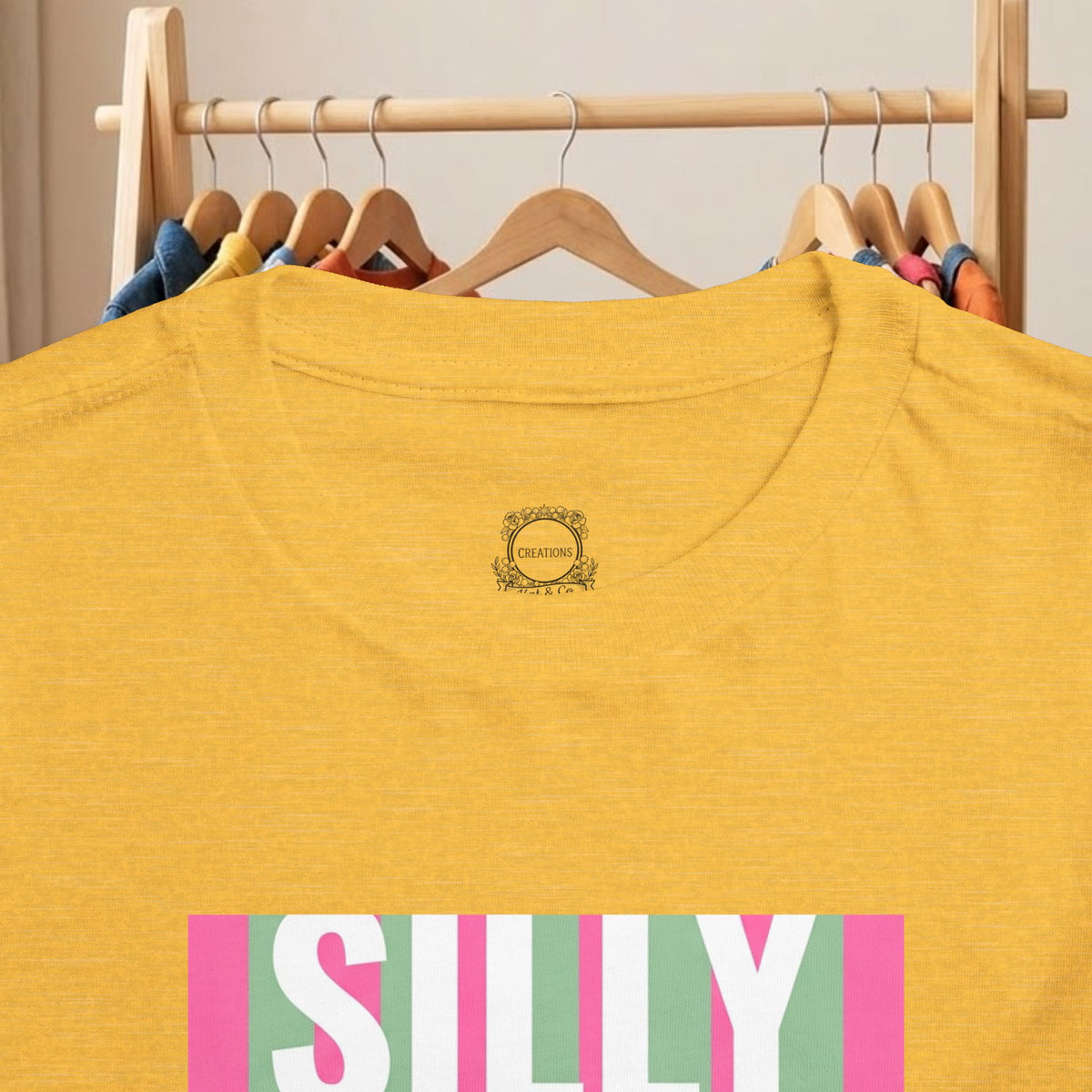 Yellow toddler tee back with small gold crest logo at neckline