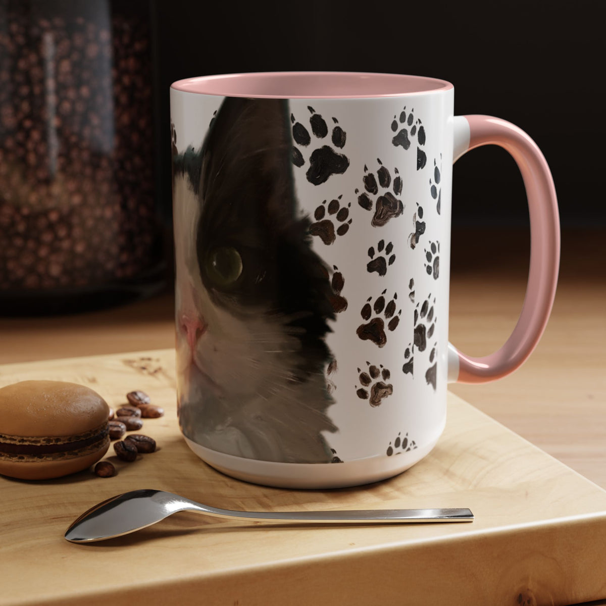 Black cat face accent coffee mug with paw print pattern, white body, pink handle