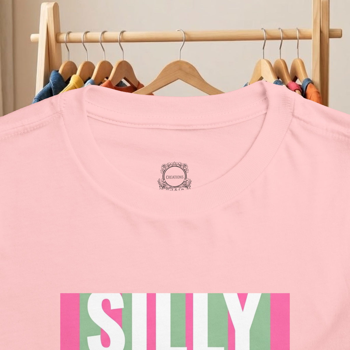 Pink toddler tee close-up: round neck and colorful “SILLY” duck graphic