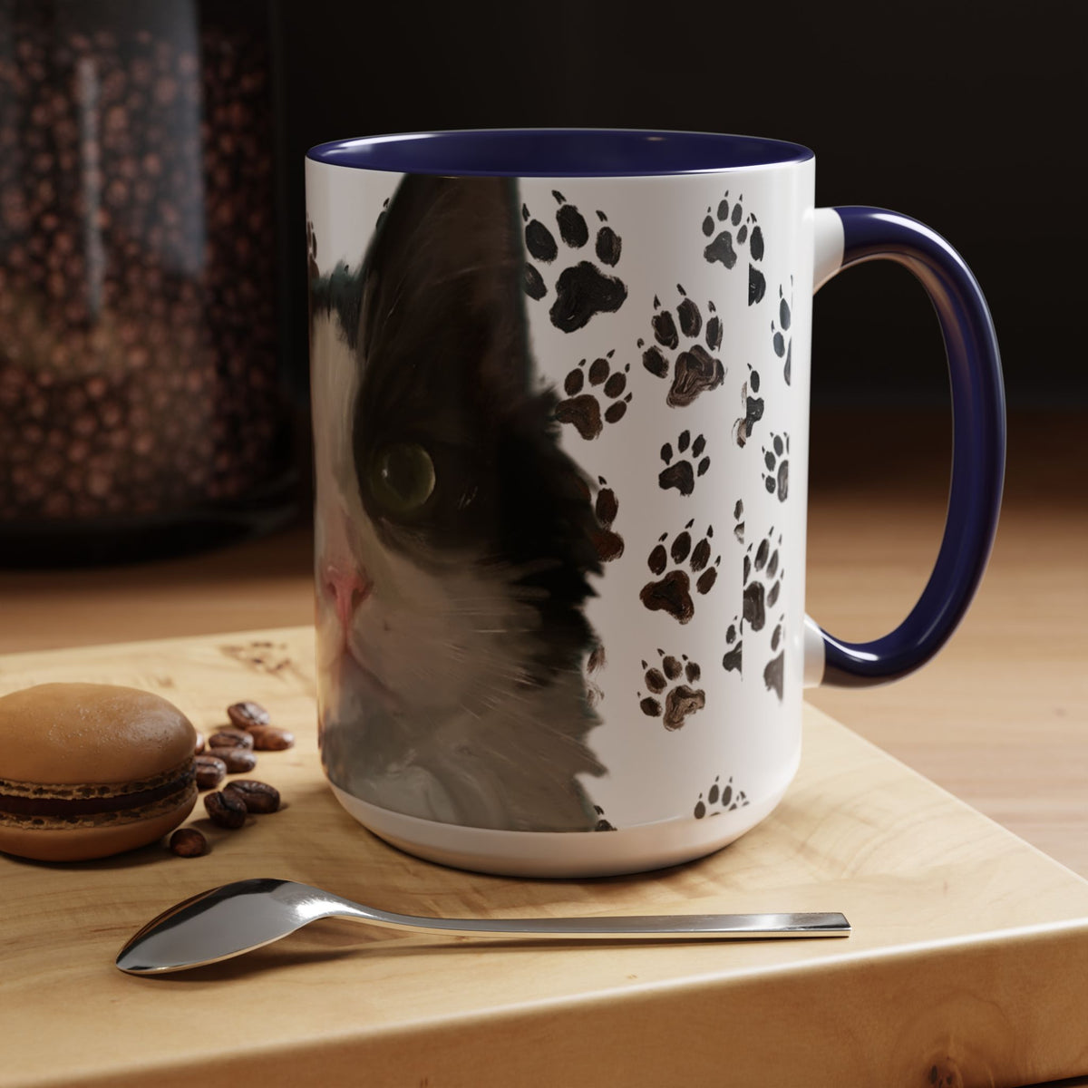 Black cat face accent coffee mug with paw print pattern, white body, navy handle