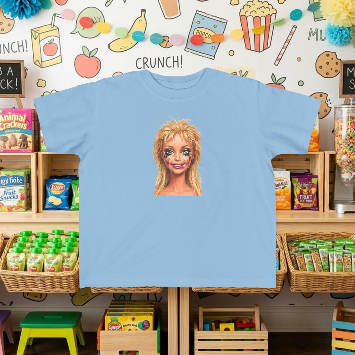Powder blue toddler tee with smudged doll face graphic print on front