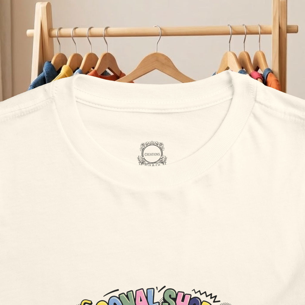 White toddler t-shirt with small chest logo and partial front graphic