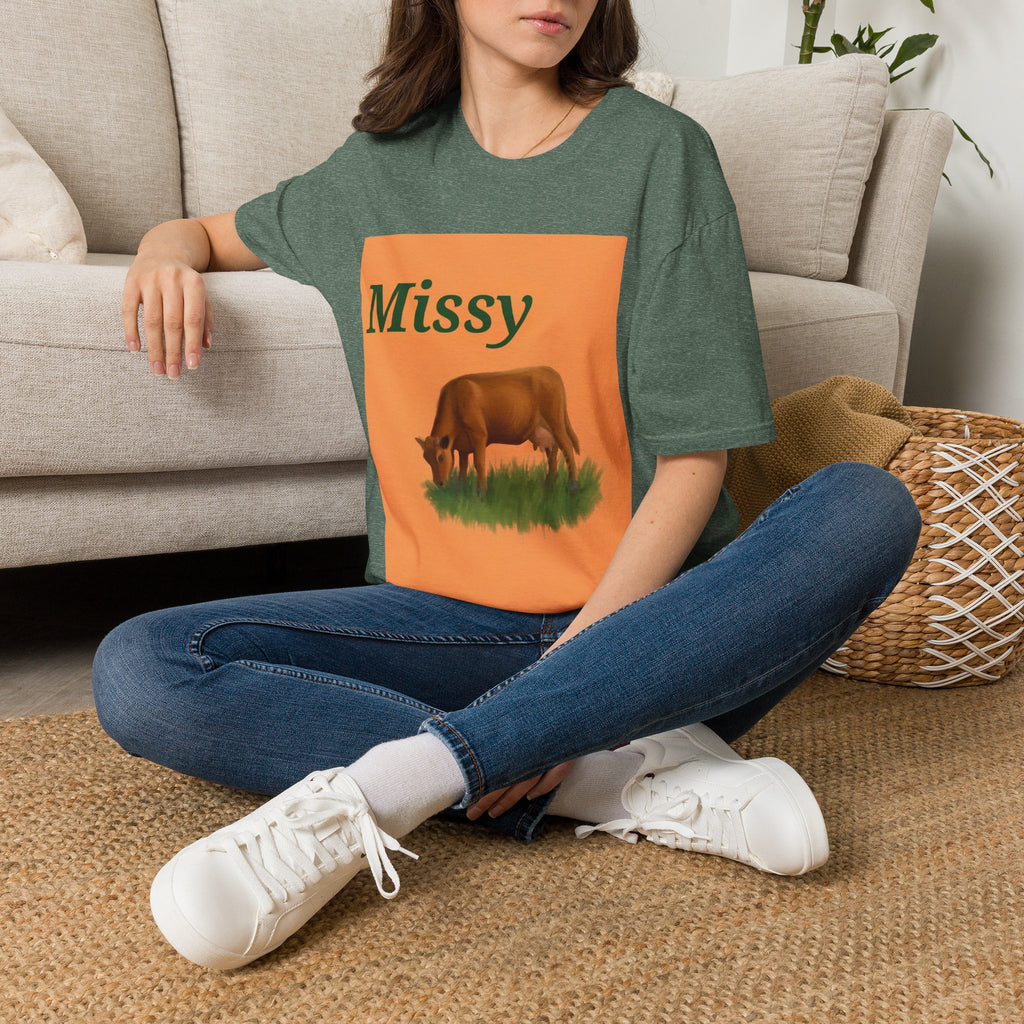 Dark green heather crew-neck t-shirt with orange “Missy” grazing cow graphic.