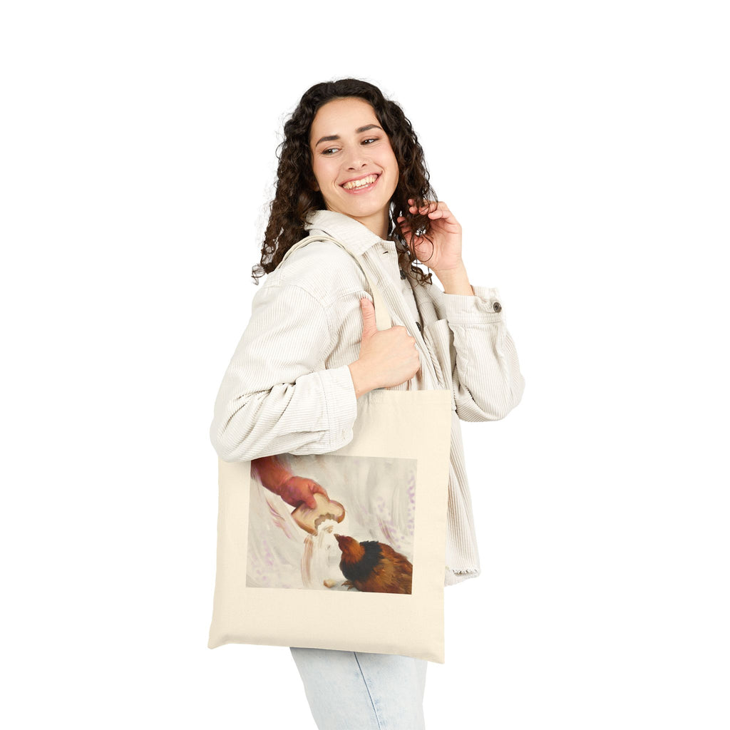 Natural canvas tote bag with vintage hen feeding illustration, carried by a person.