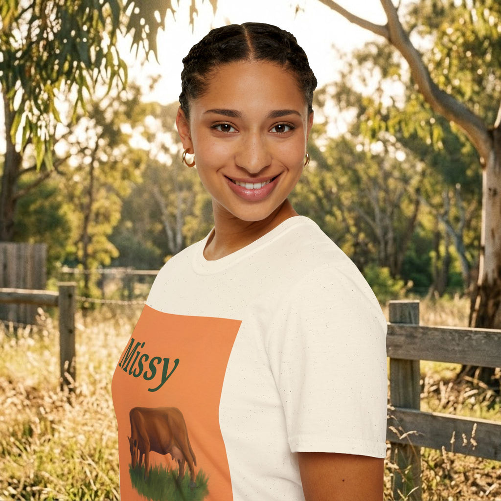 White crew-neck t-shirt, side view, with orange “Missy” grazing cow front print.