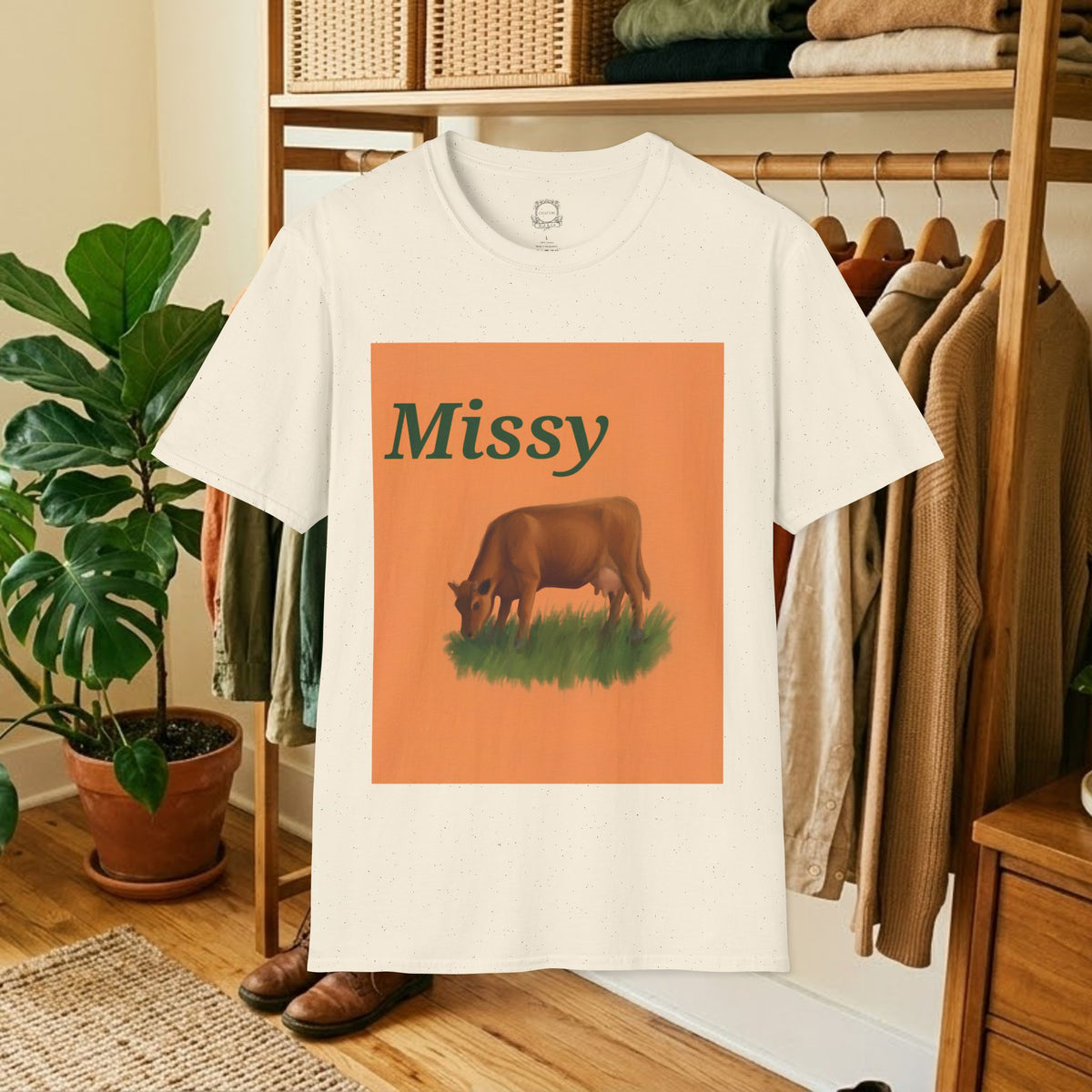 White crew-neck t-shirt with orange square “Missy” grazing cow graphic