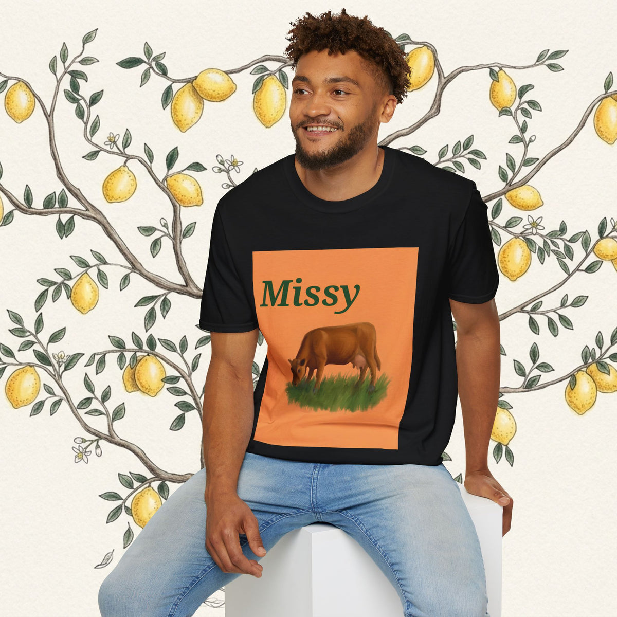 Black crew-neck T-shirt with orange 'Missy' panel and grazing cow illustration