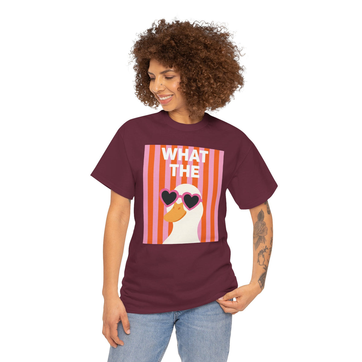 Maroon cotton graphic tee worn by model, featuring “WHAT THE” striped portrait and heart sunglasses.