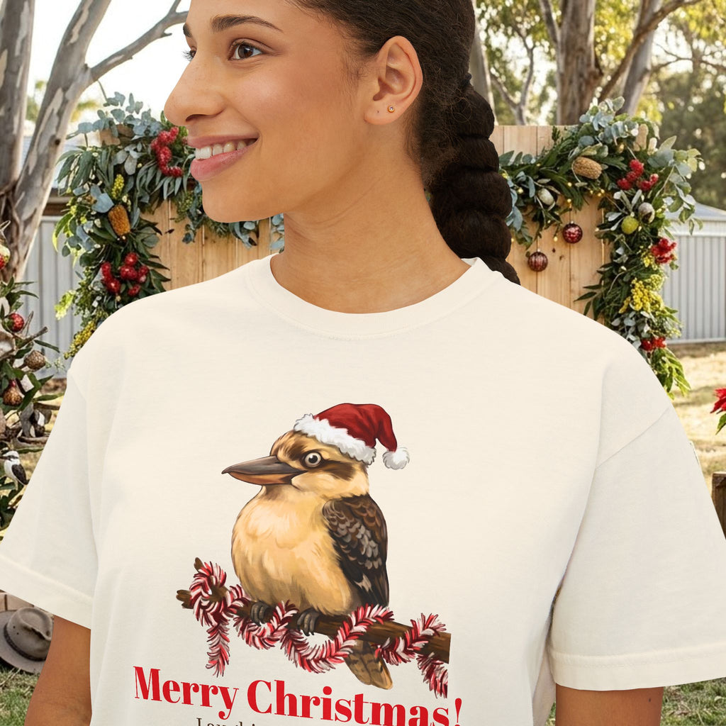 Cream short-sleeve crewneck t-shirt with printed bird wearing a Santa hat and “Merry Christmas”